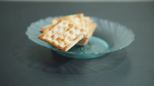 Crackers Being Arranged in Decorative Bowl