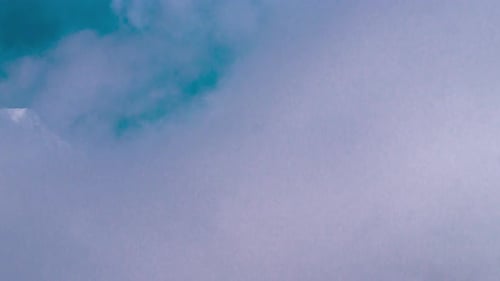 Snow Capped Mountain Peak in the Clouds