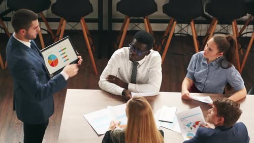 Business Team Discussing Data at Modern Office Meeting