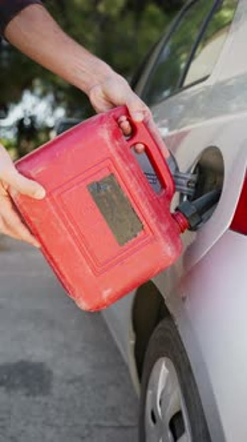 Pouring Gasoline Into the Car