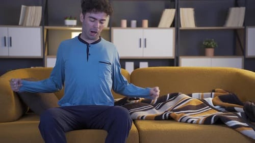 Man Rests and Falls Asleep on Yellow Couch