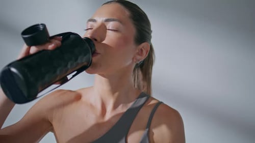 Tired Woman Drinking Water From Sports Bottle Gym Closeup Girl Sipping Liquid
