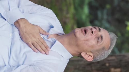 Vertical Video of Man with lung problem is experiencing shortness of breath.