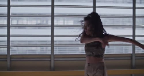 Young Woman Dancing in Urban Setting