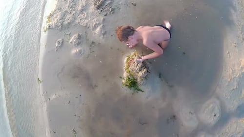Child on the Beach Building a Sand Castle