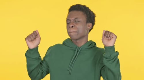 Young Adult Dancing Against Yellow Background