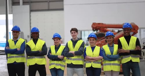 Multiracial Engineers Working Inside Robotic Factory African