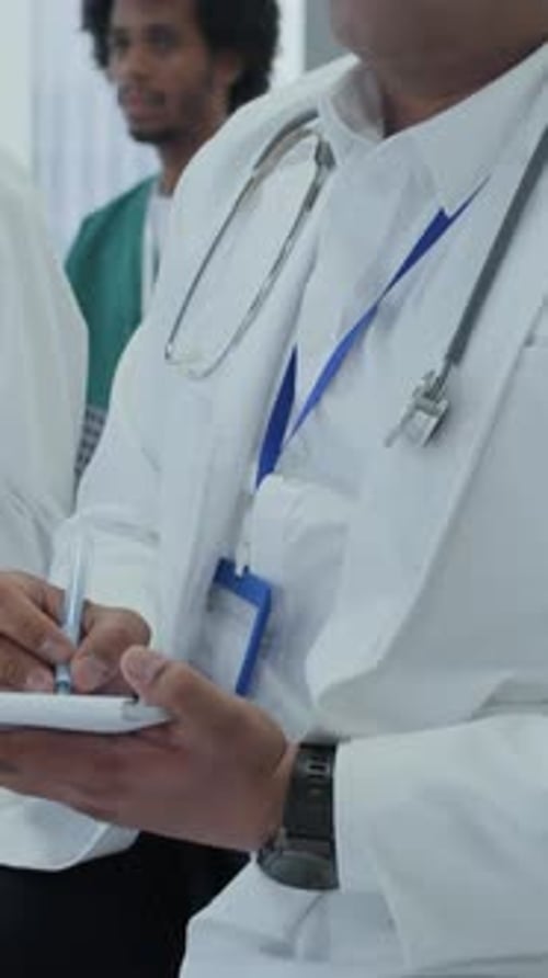 Doctors Attending Meeting and Taking Notes