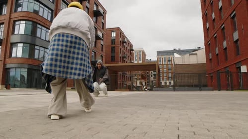 Young Adults Dancing in Urban Apartment Exterior