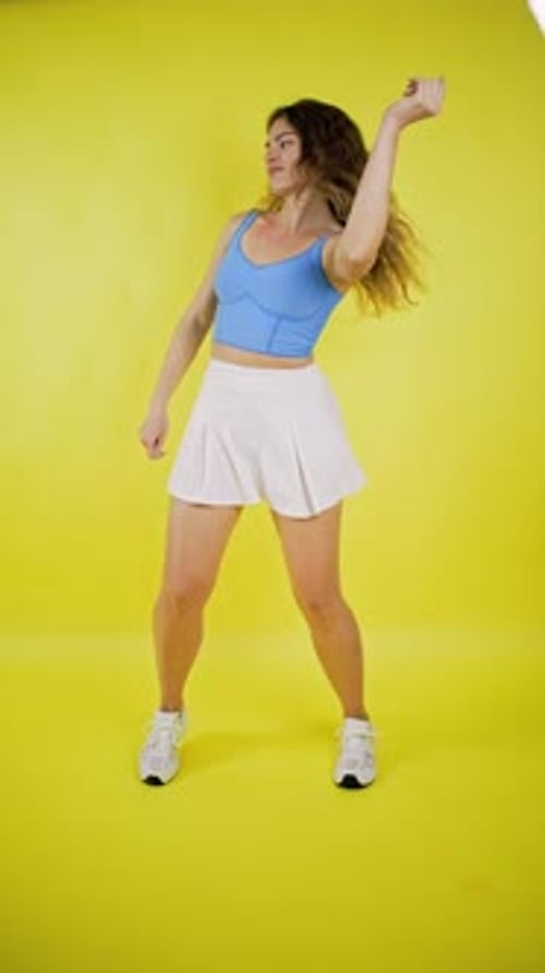 Woman Dancing Energetically on a Yellow Background