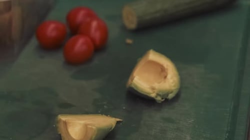 Man Slicing Fresh Avocado on Cutting Board