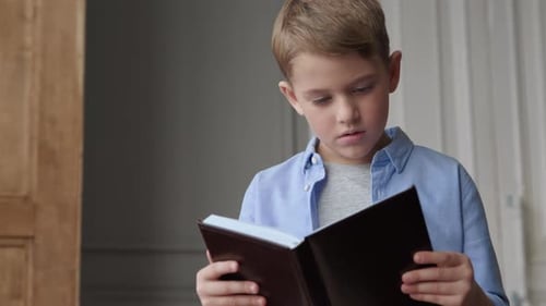 One clever boy reads a book at home shot on canon cinema eos camera