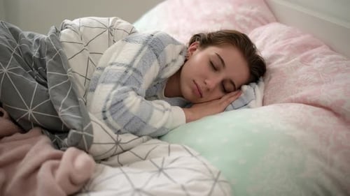 Woman Sleeping Peacefully in Bed at Home