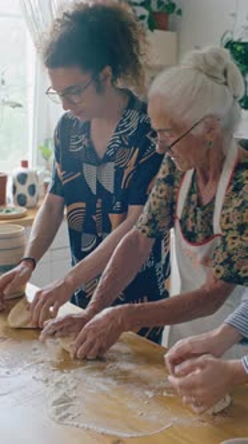 Three People Kneading Dough Together in Home Kitchen