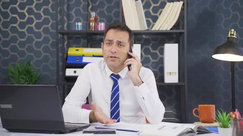 Man in Office Talking on Smartphone