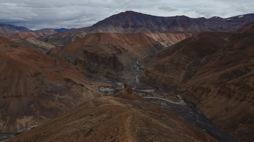 Dry Valley with Winding River and Red Hills