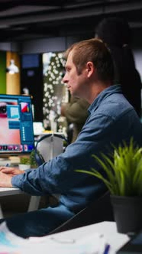 Man Works at Computer in Office at Night