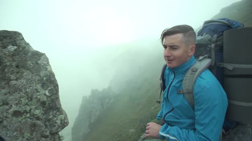 A Boy Tourist Takes a Selfie in the Mountains
