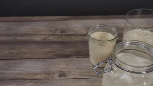 Freshly Baked Sourdough Bread and Active Starter Jars