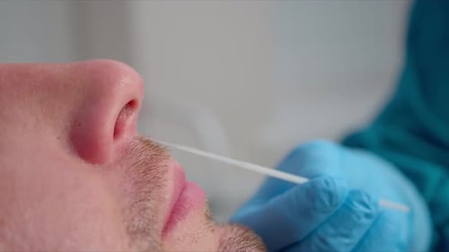 Man Gets Nasal Swab Test in Hospital Close Up