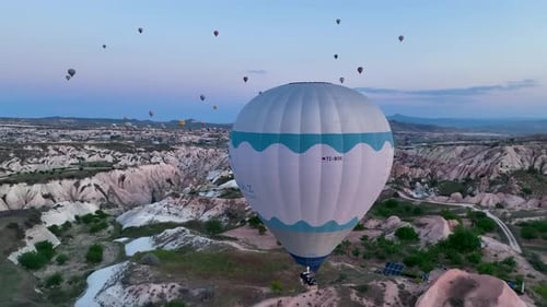 Hot Air Balloons Fly Over the Mountainous Landscape of Cappadocia Turkey
