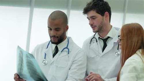 Medical Team Analyzing X-Ray in Hospital