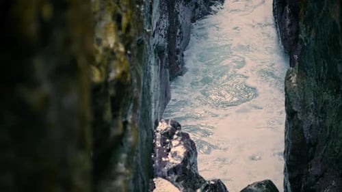 Waves Breaking at Ocean Cliff Surface Closeup. Water Splashing at Empty Stone