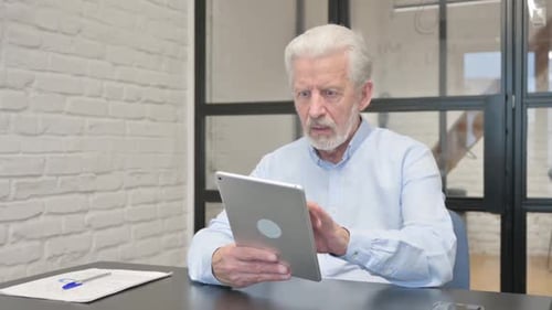 Senior Businessman with Loss on Tablet in Office