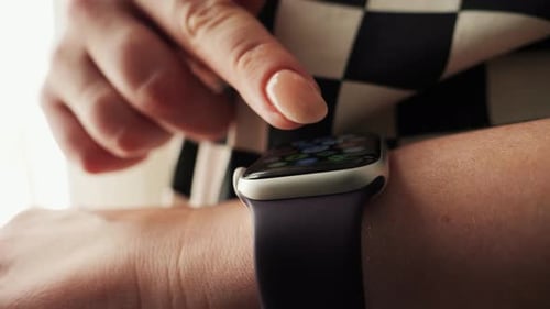Woman Interacting With Smart Watch on Wrist
