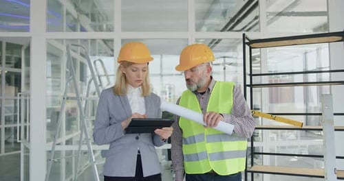 Portrait of woman main manager of building project inspecting with engineer building works