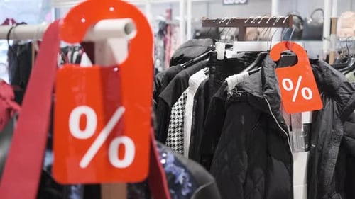 Clothing on Racks at Retail Store on Sale
