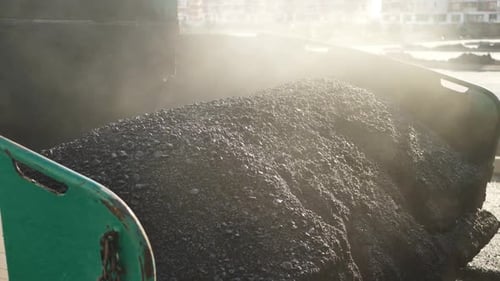 An Asphalt Spreader or an Asphalt Paver Machine on a Road Construction Site