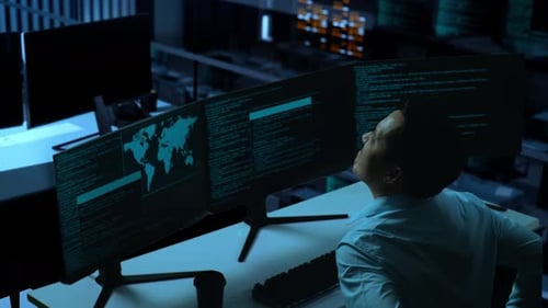Side View Of Asian Man Having Backache While Write Code With Multiple Computer Screens In Office