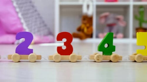 Wooden Toy Train with Numbers Moving Across Floor