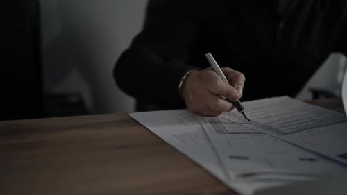 Man Reviews Documents in Urban Office Environment