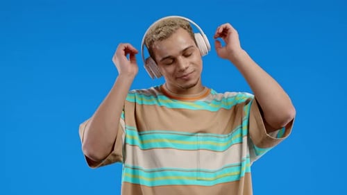Young Man Listening to Music with Headphones Dancing