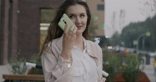 Young Woman Talking on Phone in the City