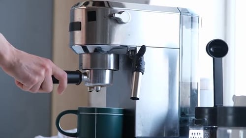 Espresso Machine Brewing Coffee into a Green Mug