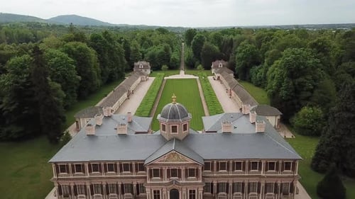 Aerial footage of a massive German palace with green lawn at the back, 4k