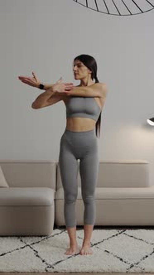 Woman Stretching Arms in Living Room