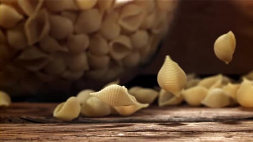 Dry Pasta Falls on a Wooden Table Filmed on a Highspeed Camera at 1000 Fps
