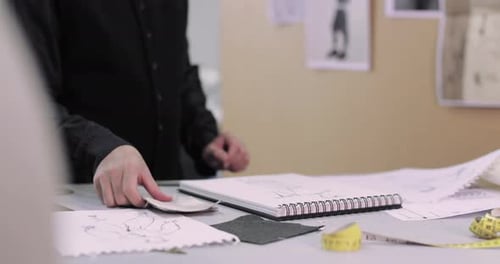 Fashion designer selecting fabrics for designs