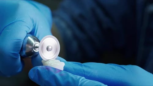 Hands Make Dental Crown with Tool