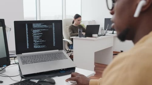 Young Man And Woman Working In IT Company Office