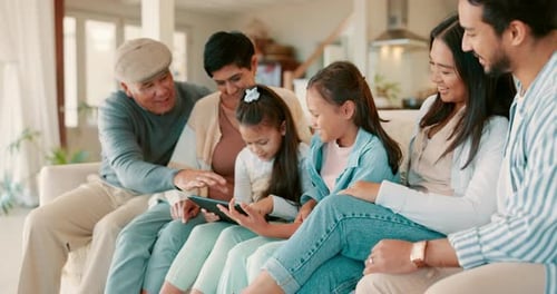 Multigenerational Family Relaxing Together With a Tablet