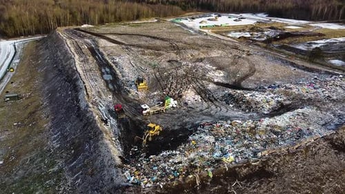 Aerial flyover landfill full of trash, pollution environmental problem, garbage, trucks dump waste p