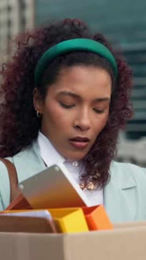 Stress, business and woman with box in city for travel, dismissal and department shutdown