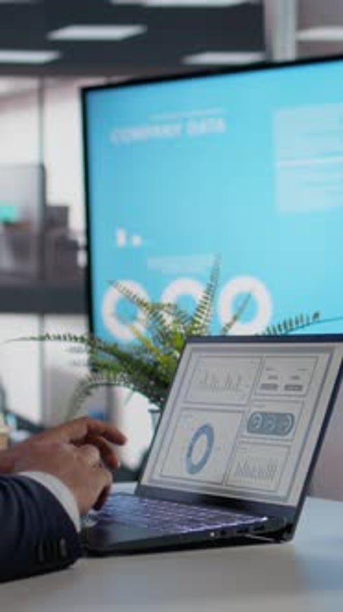 Vertical Video KPIs on Tablet and Laptop CEO Makes Analysis Company Data on Screen