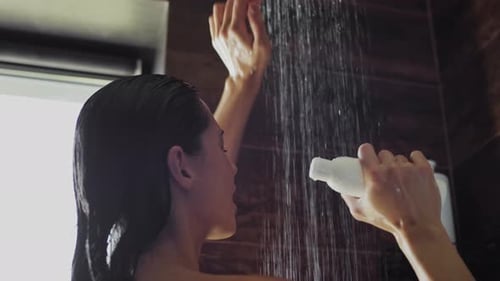 Woman Singing in Shower with Bottle