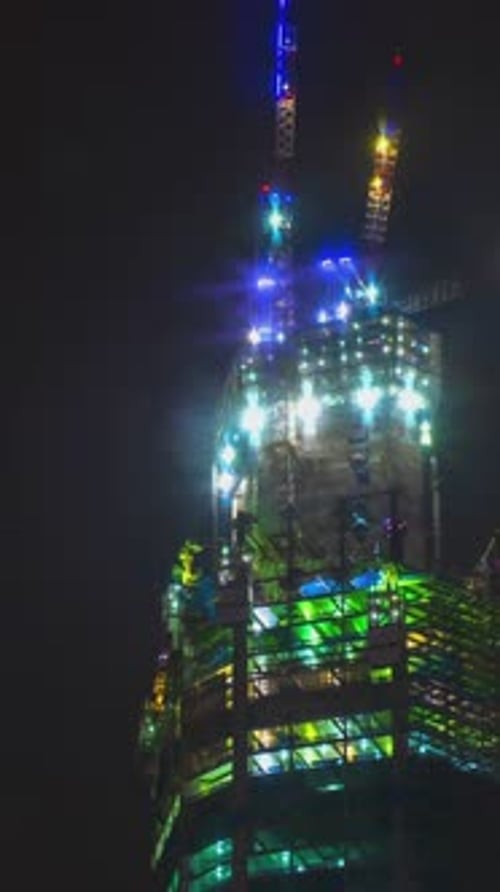 Night Timelapse of Works at Highrise Construction Site Closeup Modern Condo Office Building Cranes